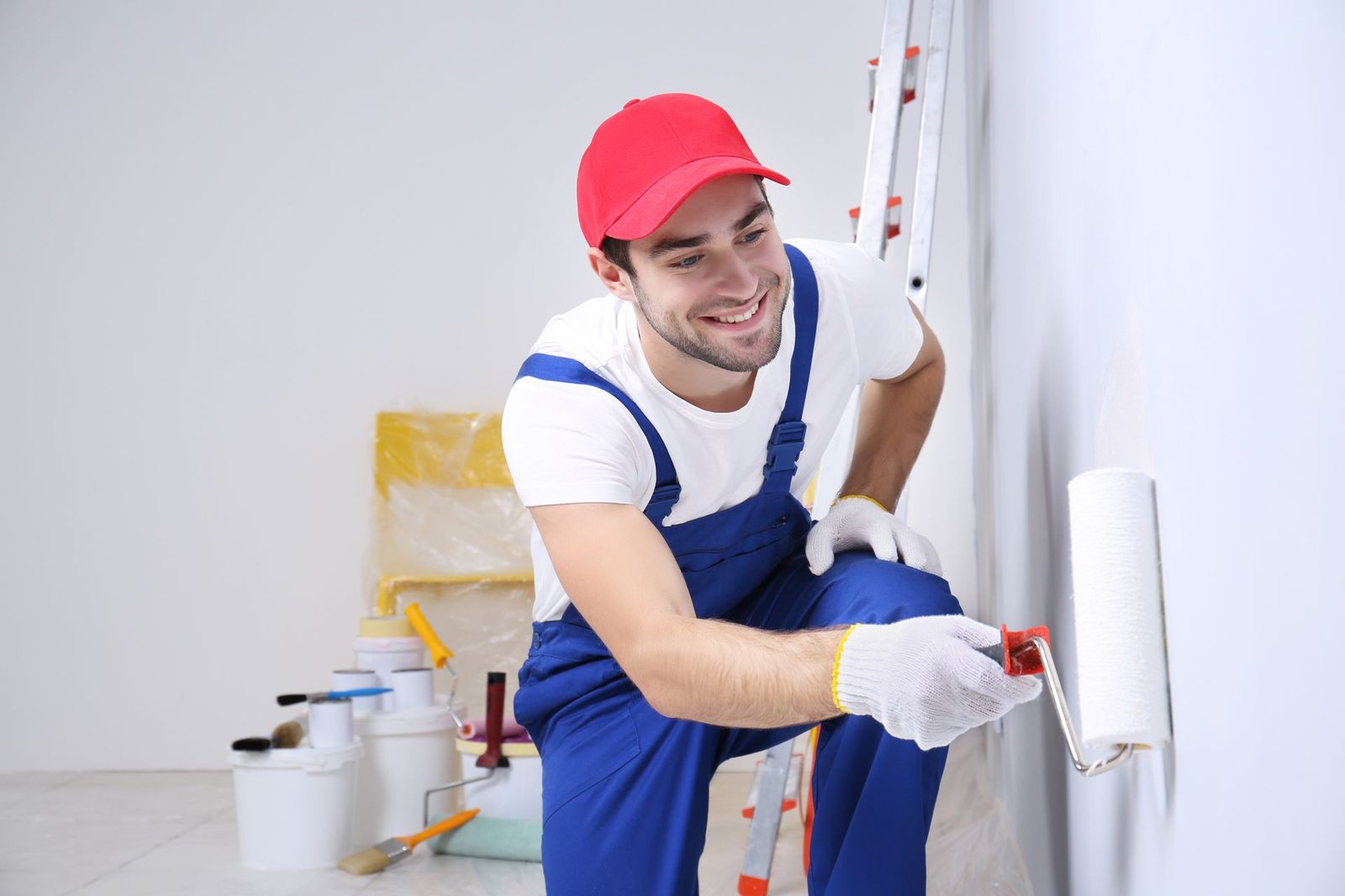 Painter applying a fresh coat with a roller